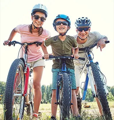 A family doing a photoshoot with their bike, capturing beautiful moments and memories at Fairbridge Village