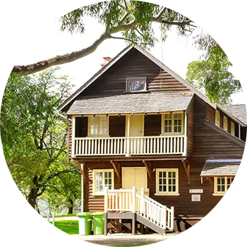 Cosy brown cottage with white balcony at Fairbridge Village