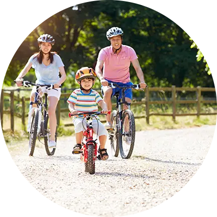 Family wearing helmets while cycling at Fairbridge Village
