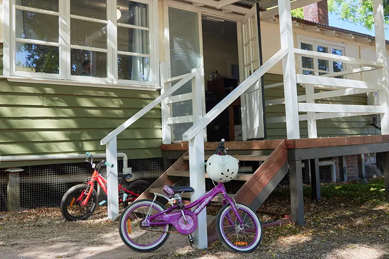Two bicycles parked outside the Fairbridge Village Festival Cottage